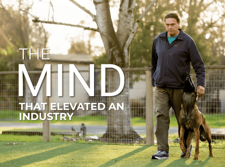 Michael Ellis performing a focused heel with his dog during training.